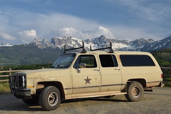 Beige Suv on Road Near Fence