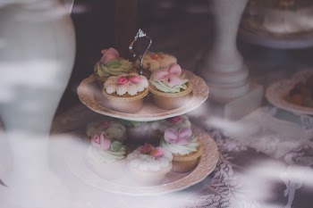 Beige White Cupcake on 2 Layer Stand Near White Baluster