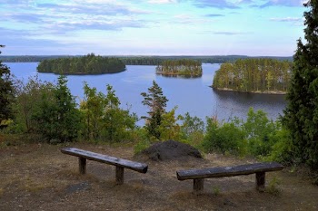 Benches Overlooking Body Of Water At Daytime