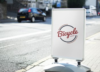 Bicycle shop sign on the street of the city Free Psd