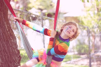 Bink, a gender non-conforming 10 year old child playing outside. 