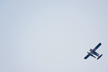 biplane on white sky