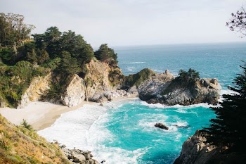 bird's-eye view of body of water beside mountain