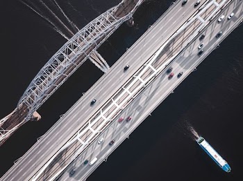 bird's-eye view of cars on gray bridge