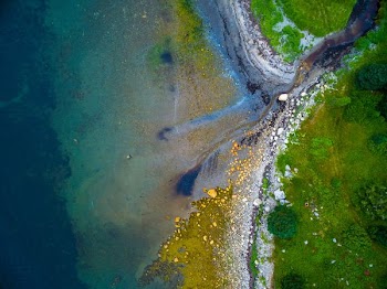 bird's eye view of plateau near body of water