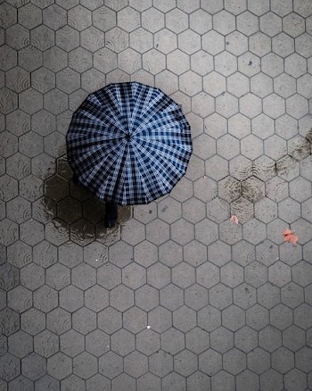 bird's eye view photograph of white and black umbrella on surface