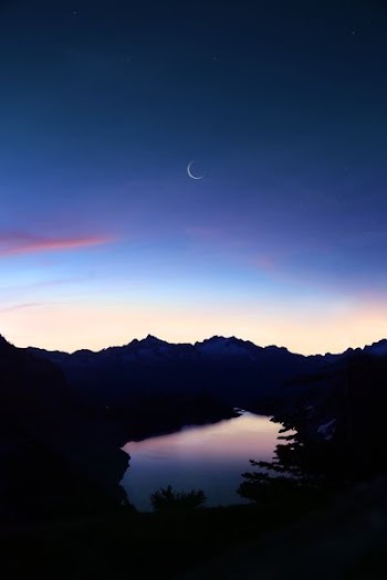 birds eye-view of lake under crescent moon