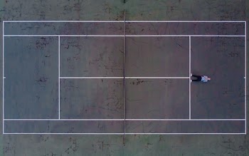 Birds Eye View Of Tennis Courts With Man