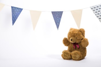 Birthday teddy bear with white backround and flags. Birthday card.