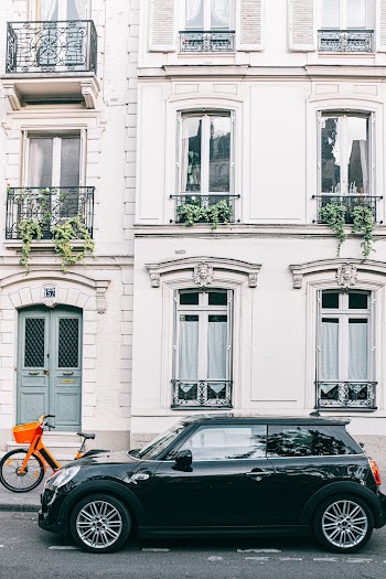 Black 3-door Hatchback Parked Beside A Building