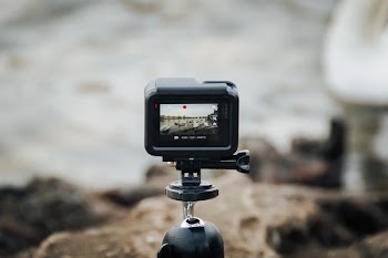 black action camera on tripod