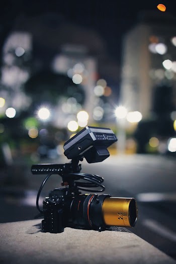 Black and Brown Dslr Camera on Concrete Surface