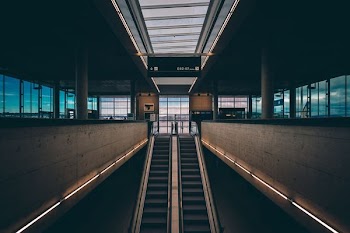 black and brown escalator inside building
