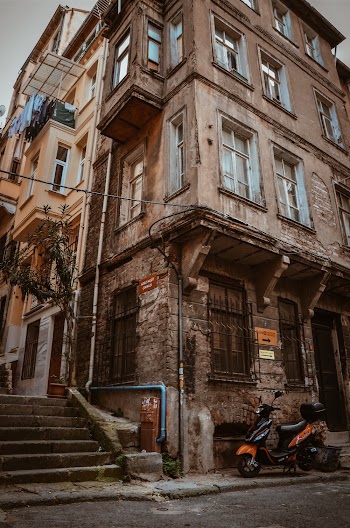 Black and Brown Motor Scooter Beside Building