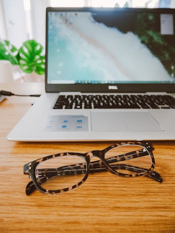 Black And Brown Tortoiseshell Eyeglasses In Front Of Laptop