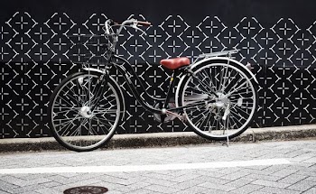 black and gray bike parked near black wall