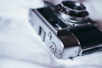 Black and Gray Bridge Camera on White Textile
