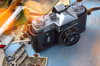 Black and Gray Camera Body on Gray Surface
