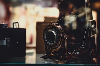 Black and Gray Camera on Glass-top Surface