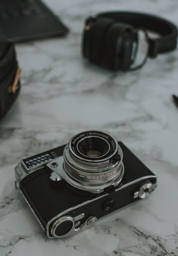Black and Gray Camera on White Marble Surface
