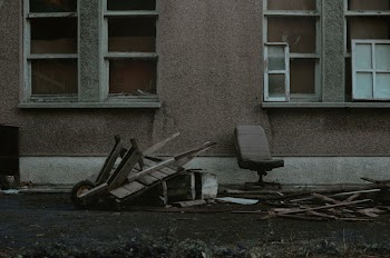 Black and Gray Chair Beside Brown Concrete Building