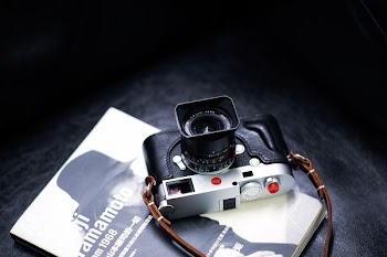 black and gray digital camera on book