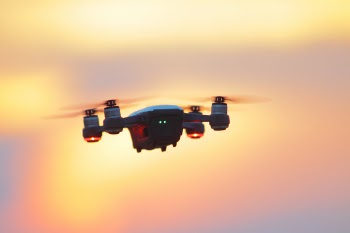 Black and Gray Dji Mavic Pro Drone Hovering at Golden Hour