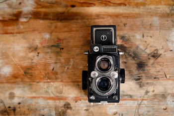 Black and Gray Land Camera on Brown Surface