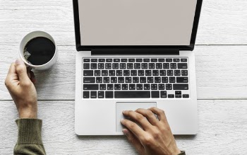 Black and Gray Laptop Computer on Brown Wooden Surface