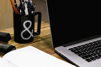 black and gray laptop near black ceramic mug