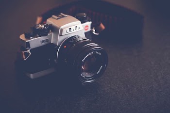 black and gray Leica camera on black table