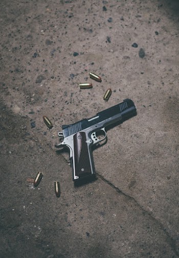 Black and Gray Semi-automatic Pistol on Brown Surface