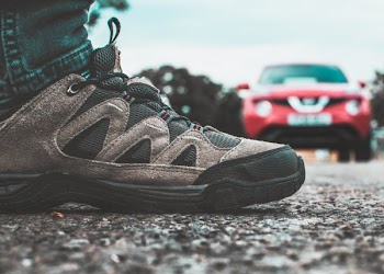 Black and Gray Shoe Near Red Vehicle