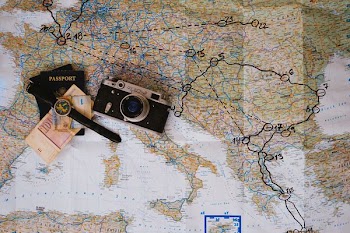 black and gray SLR camera on map