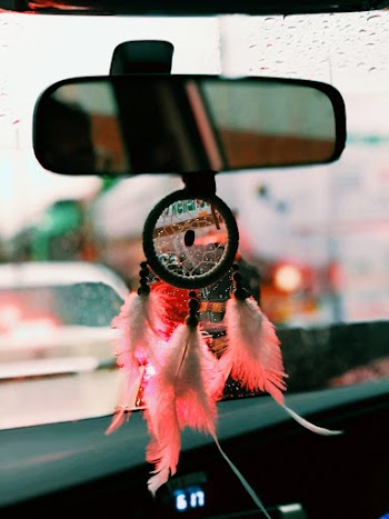 Black and Pink Dreamcatcher Hangs on Vehicle Rear Mirror