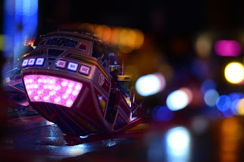 Black and Pink Speed Vehicle With Lights on Background