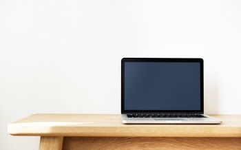 Black and Silver Laptop Computer on Brown Wooden Desk