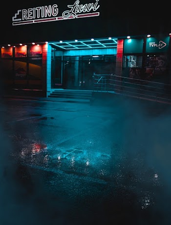 Black and White Building With Lights Turned on during Night Time