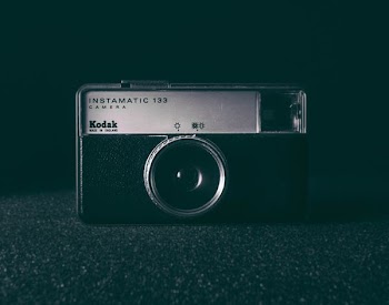 black and white camera on black surface