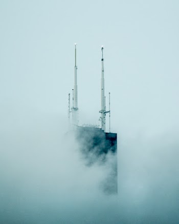 Black and White Concrete Tower Covered With Clouds