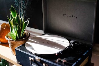 Black and White Crosley Vinyl Record Player on White Wooden Frame