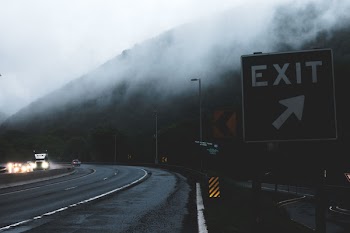 Black and White Exit Signage on Roadside