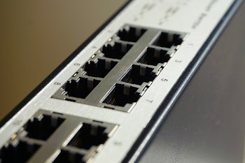Black and White Lan Port Router in Shallow Focus Photography