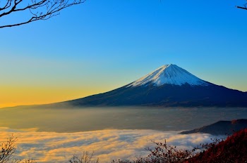 Black and White Mountain over Yellow White and Blue Sky