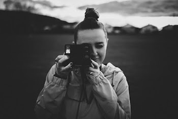 Black and White Photo of a Woman Capturing Photo