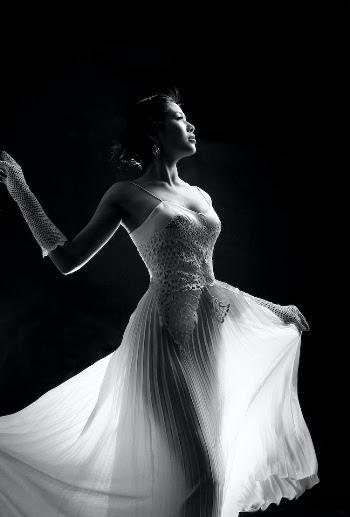 Black and White Photo of a Woman in a Gown