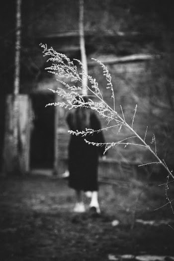 Black and White Photo of a Woman Walking
