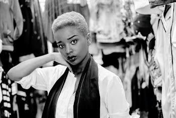 Black and White Photo of a Woman Wearing White Top and Scarf