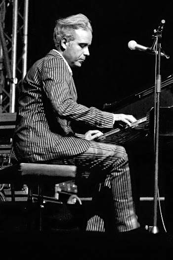 Black And White Photo of Man in Striped Suit