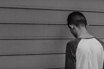 Black and White Photo of Man Looking Down